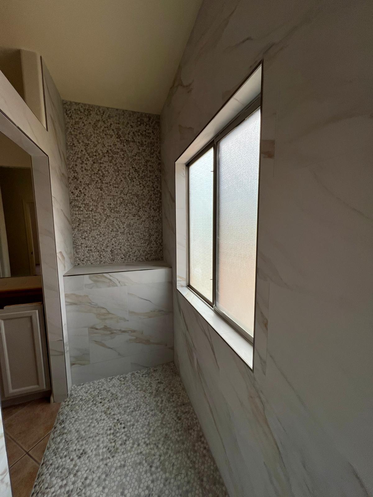 Shower with bench and pebble floor
